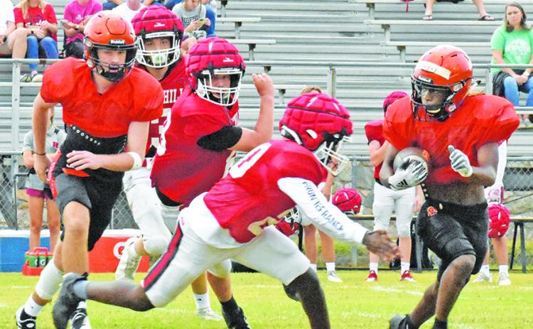 SOMERVILLE’S HERSCHEL CONWAY carries the ball against Rosehill Christian School. Also pictured is blocker Kutter Rohrbach.