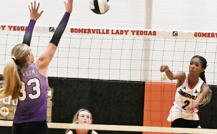SOMERVILLE’S KARYS ELLIS gets the ball past the outstretched arms of an Aggieland HomeSchool blocker during Somerville’s match against the Lady Panthers last Friday in Somerville. Tribune photo by Denise Squier