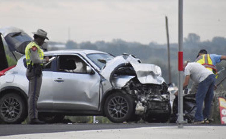 THE DPS INVESTIGATES at this two-car collision on Thursday morning, Sept. 3, on State Highway 212 West at the F.M. 60 intersection. One driver was injured/ Tribune photo by Roy Sanders