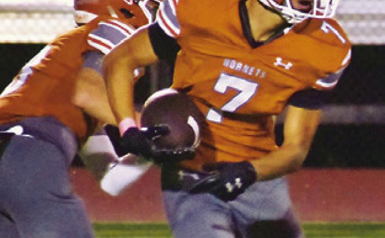 E.J. ROGERS carries the ball for Caldwell against Giddings last Friday.