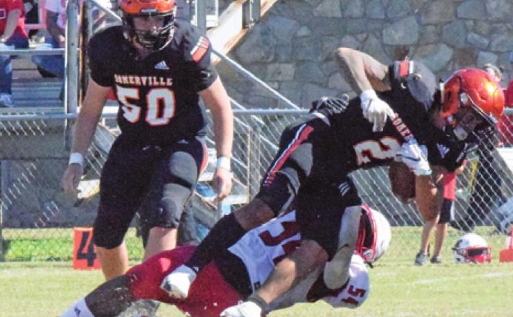 SOMERVILLE’S JEREMIAH TEAGUE is tackled by a Burton defender during the Yegua’s last game of the season on Saturday. Also pictured is Ross Dubois for Somerville. -- Tribune photo by Miranda Jones