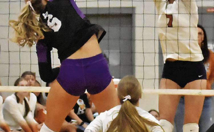 CALDWELL’S CLOEY RUSS attempts to block a spike from Thrall’s Brenna Tucek during the Lady Hornets’ match against Thrall on Friday at Hornet Gym. See story inside for more about the match. Tribune photo by Roy Sanders
