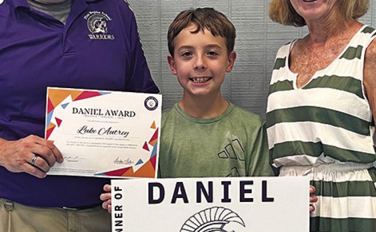 LUKE AUTREY recently received the Daniel Award as the Student of the Month for First Baptist School. He is pictured with Kristian Pearson, FBC Children’s Minister, and Sandy Malone, FBS Board Member.