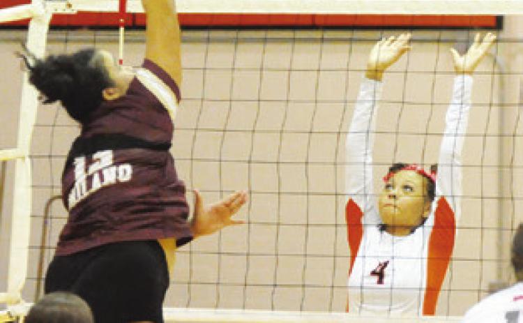SOMERVILLE’S GABBY JACKSON prepares to attempt to block a hit from a Milano player during the Lady Yegua-Lady Eagle match last Friday in Somerville. -- Tribune photo by Denise Squier