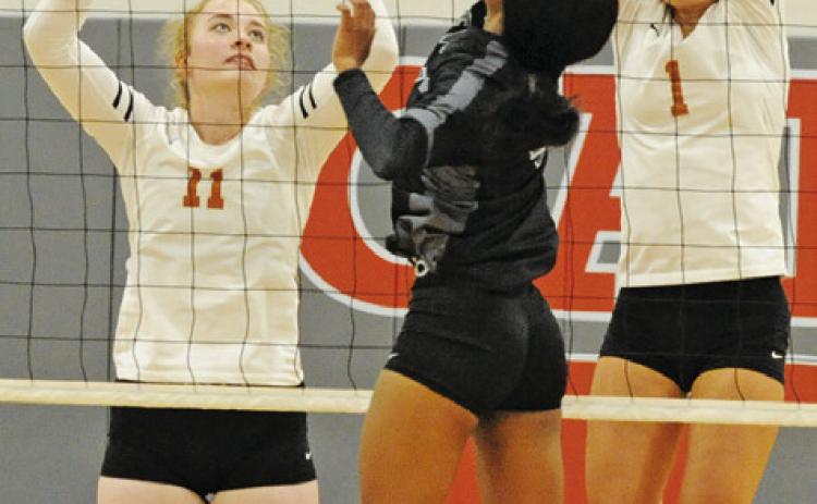 CALDWELL’S ASHLYN KELLUM goes up to attempt to block a hit by a Manor New Tech player during the Lady Hornets’ win last Friday. Also pictured is Jackie Pinkerton. -- Tribune photo by Denise Squier
