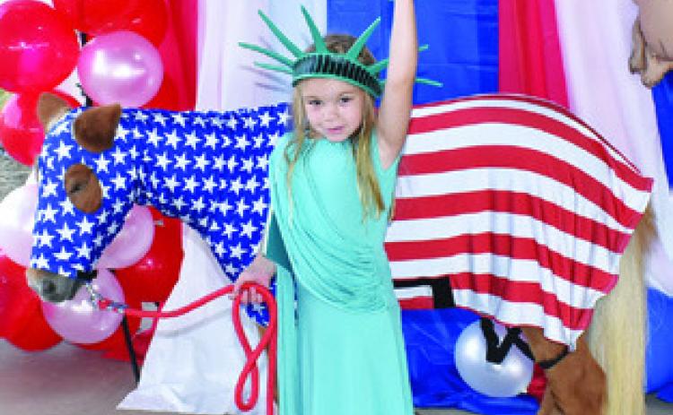 LYNLEE KOCUREK IS with Pokey on Saturday at the Burleson County Fair Pet Show at the fair pavilion. Tribune photo by Roy Sanders