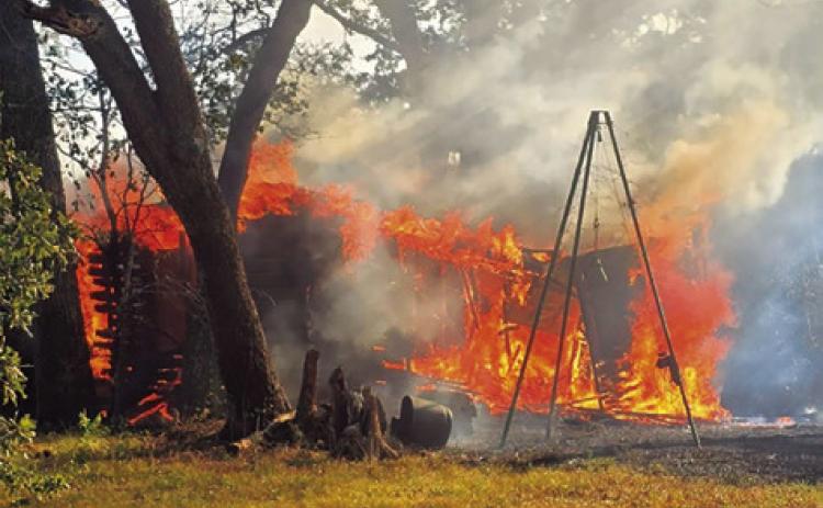 THE FIRE BURNS this building on Sunday off County Road 331. Photo courtesy of Caldwell Volunteer Fire Department