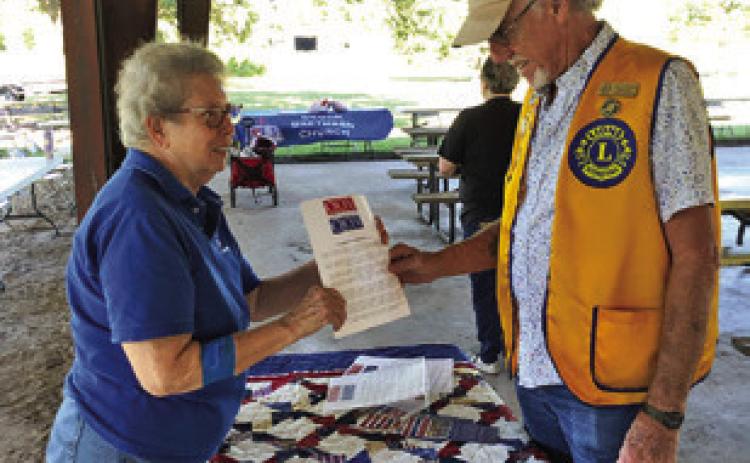 BARBARA BEHLER MANNING promotes the Quilts of Valor at the National Night Out at the Snook City Park. Photo courtesy of Barbara Behler Manning