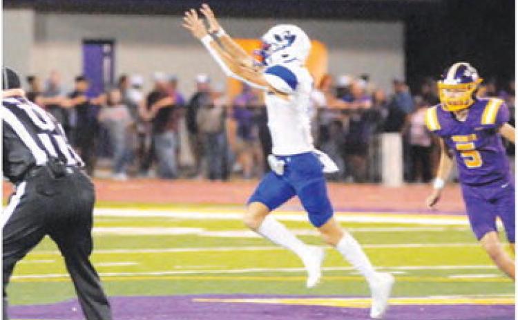 BRETT WITHEM OF SNOOK reaches high for this pass against Weimar last Friday.