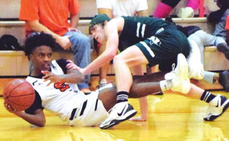 SOMERVILLE’S VERKOBE WOODBERRY fights Normangee’s Nicholas Childress for possession of the ball during the Yeguas’ 59-45 loss to Normangee last Tuesday night. -- Tribune photo by Denise Squier AAAAAAA JOHNNY LEGG tries to shoot the ball while being double-teamed by the Normangee defense. --- Tribune photo by Denise Squier