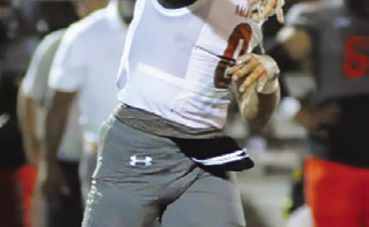 COY BECKA of Caldwell hurls this pass against Gonzales last Friday.
