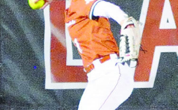 BREANN SIMS sets to throw the ball from the outfield after a Leon batter hit the ball to the warning track. -- Tribune photo by Denise Squier