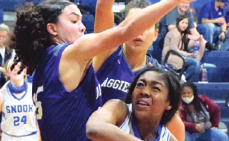 JAIVAN STRINGFELLOW is doubleteamed while trying to shoot during the Snook-Aggieland Home-School game last Monday.