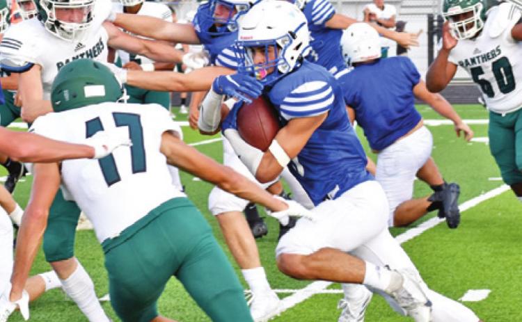 SNOOK’S JOSE GARCIA carries the ball against Normangee in last Friday’s scrimmage in Snook. -- Tribune photo by Roy Sanders