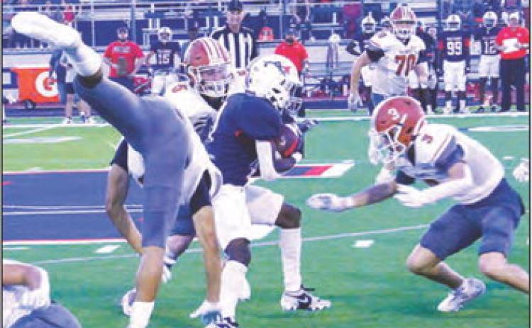 E.J. ROGERS, CORBIN Stewart and Caden Schluens defend against this Madisonville running back. -- Tribune photo by Roy Sanders