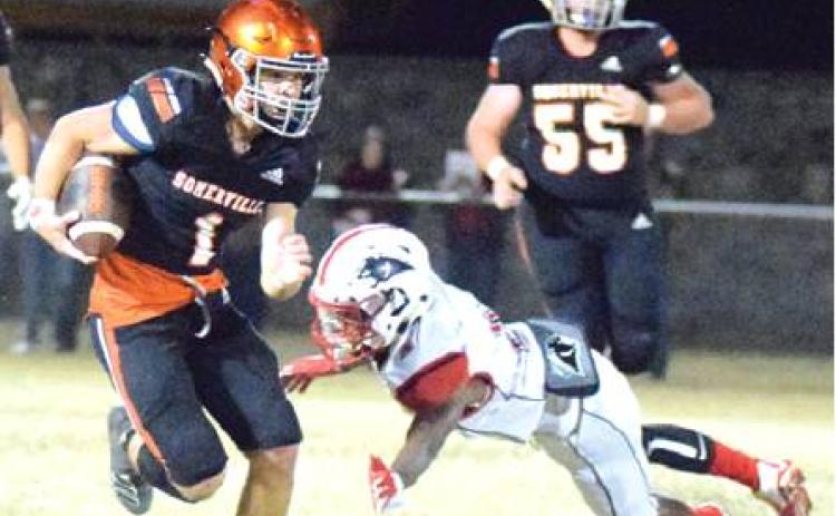 SOMERVILLE’S PHILIP HABA avoids getting tackled by a Burton defender during a quarterback keeper during Friday night’s Somerville-Burton game at The Rock. -- Tribune photo by Denise Hornaday