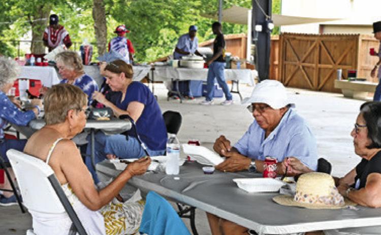 BURLESON COUNTY DEMOCRATS enjoyed a barbecue chicken dinner at their July 4th celebration on Saturday in downtown Caldwell. Tribune photo by Denise Squier