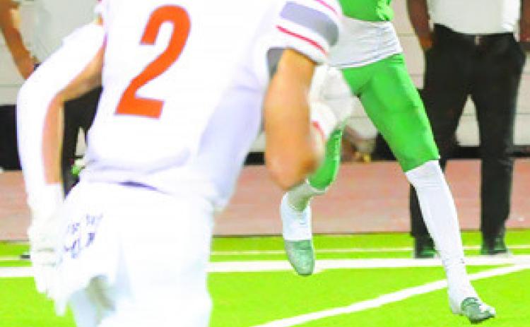 CALDWELL’S BLANE Garza moves in for a tackle as a Cuero receiver makes a catch.