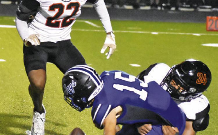 SOMERVILLE’S JAYDEN ESPINOSA and Semaj Pennygraph move in to tackle Snook’s Braedyn Fannin as the ball comes loose. Tribune photo by Roy Sanders