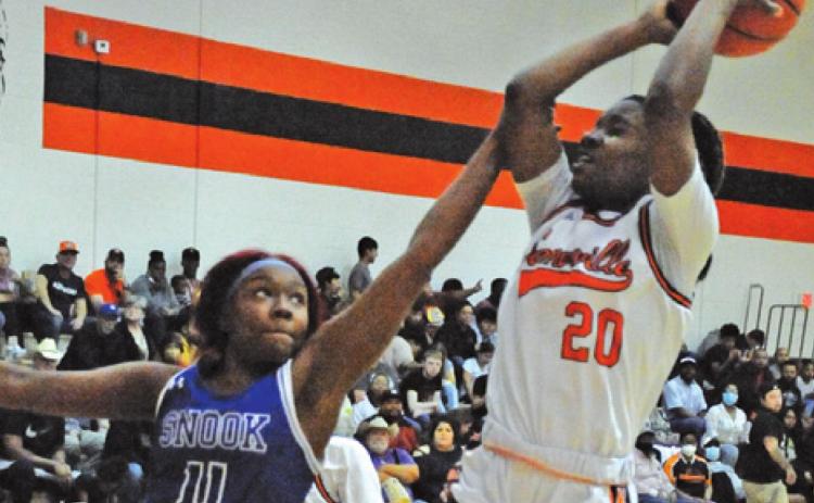 SNOOK’S LABRAYLA POOL reaches to try to keep Somerville’s Camia Martin from scoring during Somerville’s 42-14 win over Snook.