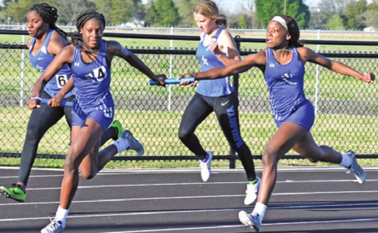 THE LOUIS SISTERS, Bre’Asia and Bre’Anna, compete in a girls’ relay race at the Bluejay Relays last week. -- Tribune photo by Roy Sanders