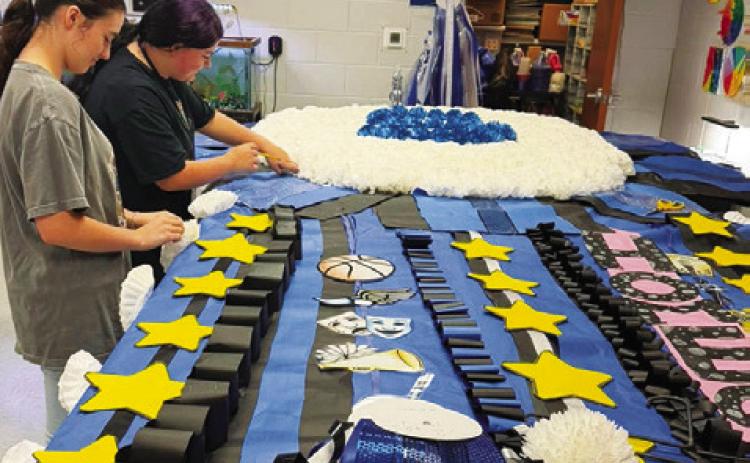 THE SNOOK ISD CTE Floral Design Club helped create the giant district homecoming mum which was set up at Bluejay Stadium last week.