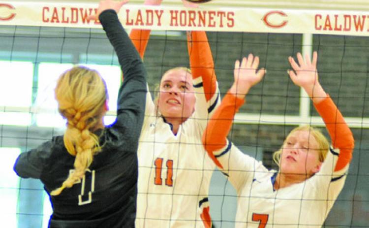 JACKIE PINKERTON blocks a hit from a Sealy middle blocker during the Lady Hornets’ 14-25, 23-25, 15-25 loss Friday night. Also pictured is Caitlyn Faust. See story inside. -- Tribune photo by Denise Squier