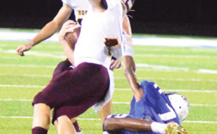 SNOOK’S DESHUN Hamilton holds onto the jersey of Thorndale’s Cain Brymer to make a tackle during the Bluejays’ home opener last Friday. -- Tribune photo by Denise Hornaday