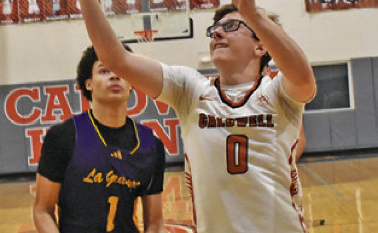 CAYDEN ZBORIL reaches for the ball last Friday against La Grange. Tribune photo by Roy Sanders