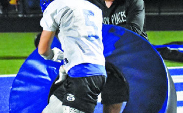 MICHAEL EATON is pictured with Coach Nolan Lanham working on this Friday night drill.