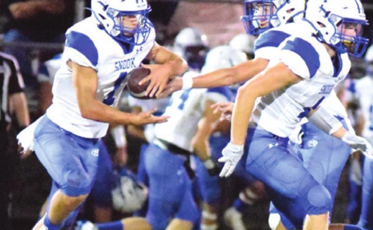 SNOOK’S J. BEAUX HRUSKA hands off to Garrett Lero while Garrett Hyvl looks to block during the Bluejays’ win over Somerville last Friday night at The Rock in Somerville. -- Tribune photo by Denise Squier