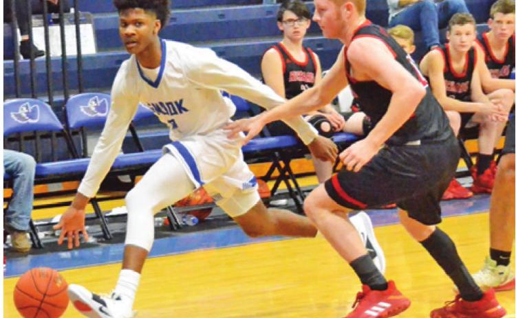 SNOOK’S JERMAINE KEARNEY dribbles the ball past this Richards defender on Jan. 14 in Snook. The Bluejays won 68-60 and later lost to Iola in the district opener. -- Tribune photo by Roy Sanders