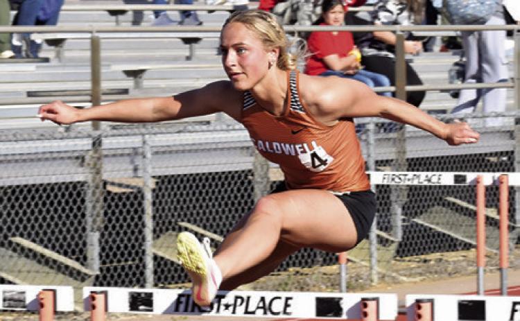 CALDWELL’S KAYLAN GROCE clears this hurdle during last week’s Happy Skrabanek Relays at Hornet Stadium. Tribune photo by Roy Sanders