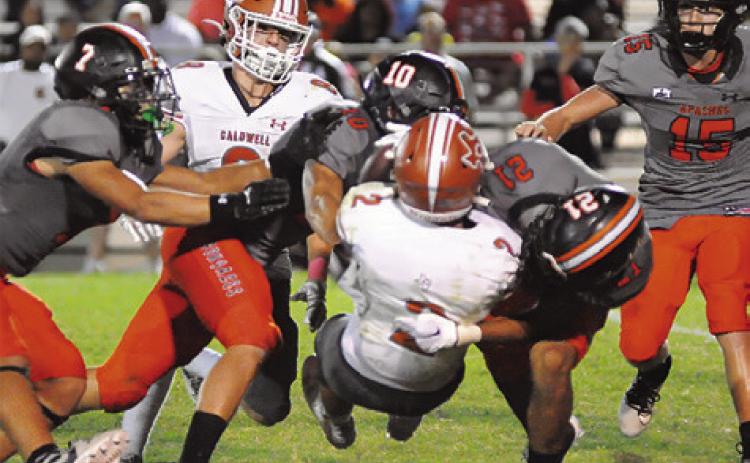 BLANE GARZA OF Caldwell is tackled by Gonzales defenders.