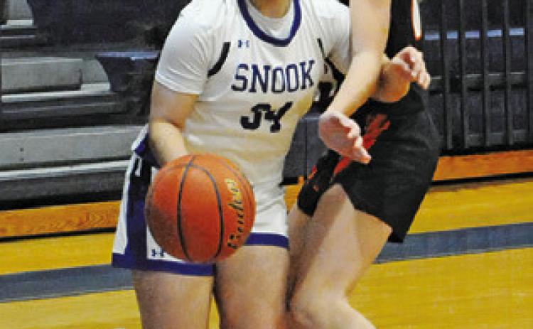 ASHLEY QUEVEDO dribbles around a Smithville player during the Snook-Smithville game last Tuesday afternoon in Snook. Tribune photo by Denise Squier