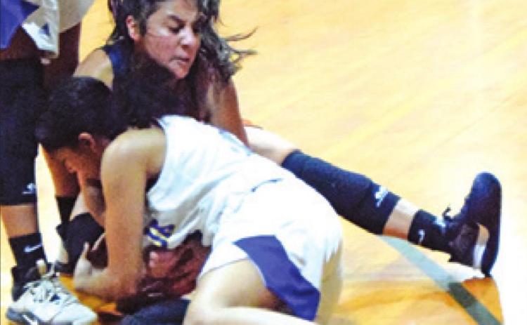 ANDREA FLORES fights with a Dime Box player for possession of the ball during Caldwell’s game against the Lady Horns last Thursday. -- Tribune photo by Denise Squier