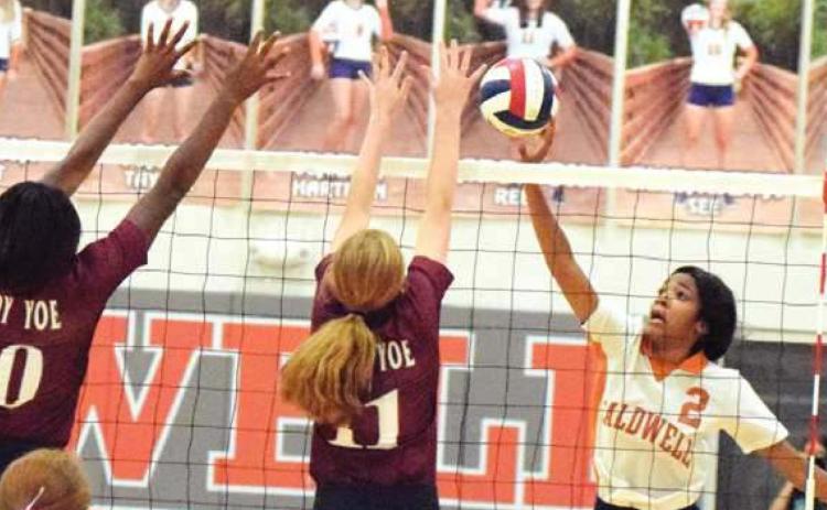 CALDWELL’S AALIYAH MASSINGILL HITS THE ball past Cameron Yoe’s Ja’kerra Holt and Averee Wadlington during the Lady Hornets’ win over the Lady Yoe last Tuesday night at the new Caldwell High School Gym. -- Tribune photo by Denise Hornaday