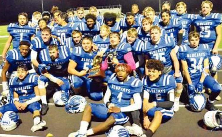THE SNOOK BLUEJAYS celebrate with their championship trophy