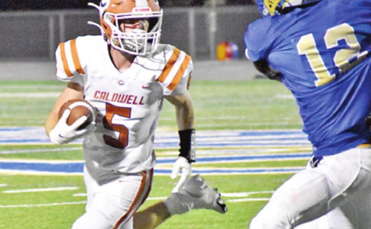 CALDWELL’S JACE ALY carries the ball against Rockdale. The Hornets lost 34-30 in Rockdale. -- Tribune photo by Roy Sanders