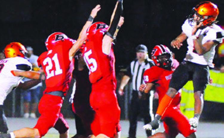 HERSCHEL CONWAY THROWS THIS pass against Burton. Also pictured is DeChristian Deere. -- Tribune photo by Denise Squier