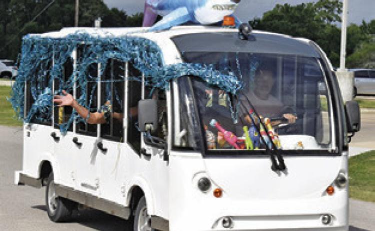 THIS WELL DECORATED bus is part of the Saturday morning parade in Somerville during the Crater Motorcycle Rally.