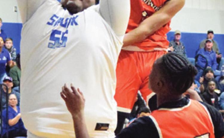 DOMINIC TUCKER blocks a shot by Snook’s James Young during their game last Tuesday night. -- Tribune photo by Denise Hornaday