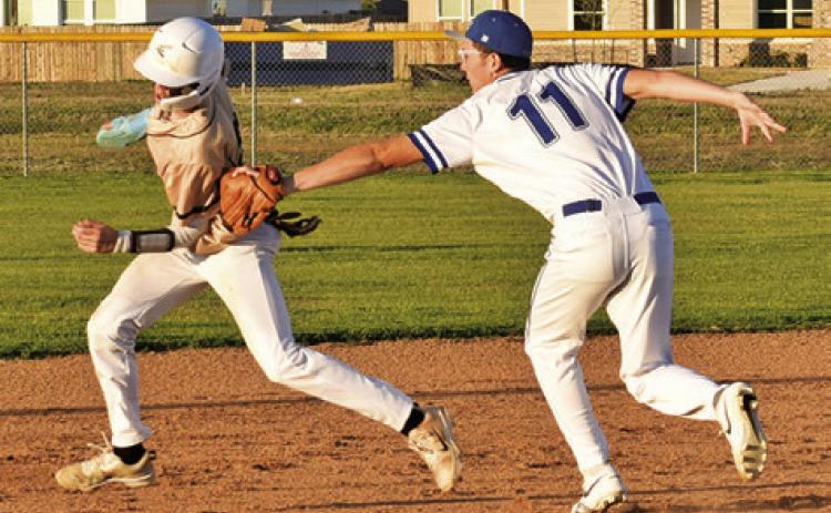 ALBERTO NORWOOD OF Snook tags this Bellville Faith Academy base runner on Friday in Snook. The Bluejays lost 12-1. Tribune photo by Roy Sanders
