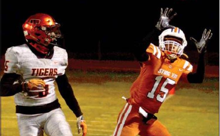 CALDWELL’S LARRY DAVIS reaches for this pass last Friday against Smithville in Caldwell. The Hornets lost 21-2 to conclude their season. Smithville advanced to the playoffs. -- Tribune photo by Roy Sanders