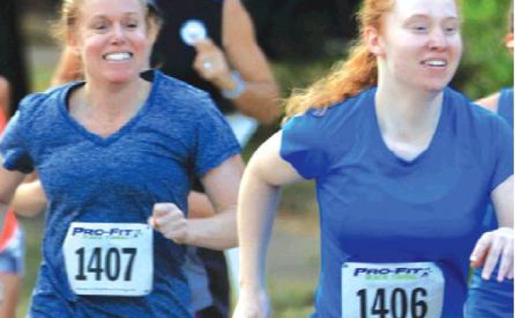 MOTHER-DAUGHTER RUNNING DUO, Tonya and Serena Foster of Caldwell, won each of their divisions during Saturday’s Kolache Krunch 5K. Tonya won the Female 45-49 division, and Serena won the Female 20-24 division. -- Photo courtesy of Andrew Wolfe Photography
