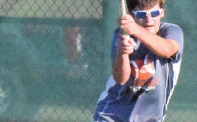 CONNOR HUGHSON returns serve during his boys’ doubles match with partner Waylon Chapman. -- Tribune photo by Denise Squier