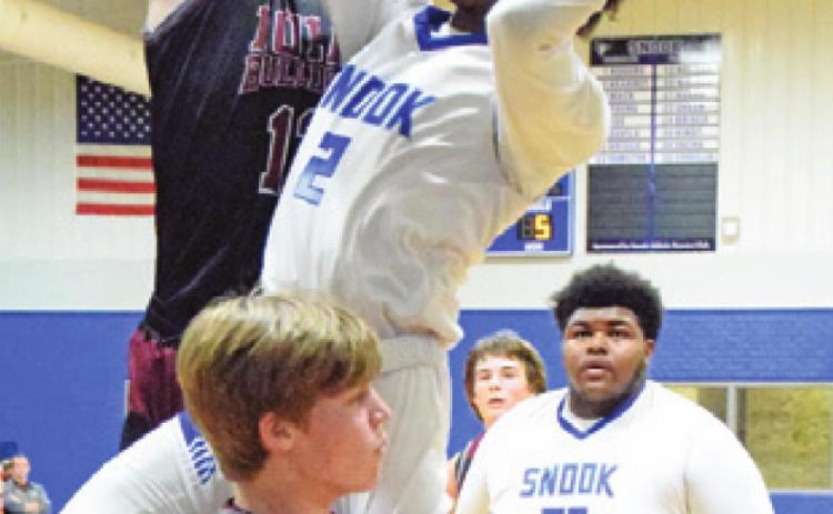 JERMAINE KEARNEY leaps to attempt a basket during the Bluejays’ game against Iola on Tuesday. -- Tribune photo by Denise Hornaday