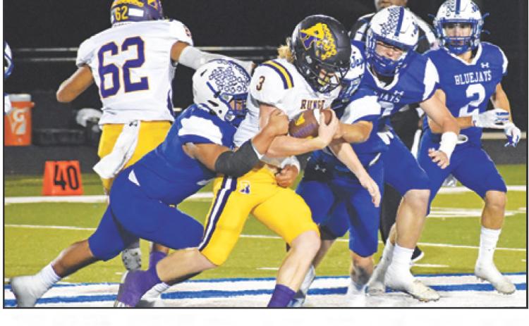THE SNOOK DEFENSE moves in for a tackle last Friday against Runge in the district opener. — Tribune photo by Roy Sanders