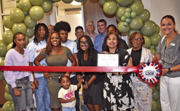 THE RIBBON IS cut on July 23 at the open house for the Somerville Family Practice Clinic. The ribbon cutting and open house was well attended. Cutting the ribbon is Rochelle Adams, and Susan Mott of the Burleson County Chamber of Commerce is next to her. See story inside.