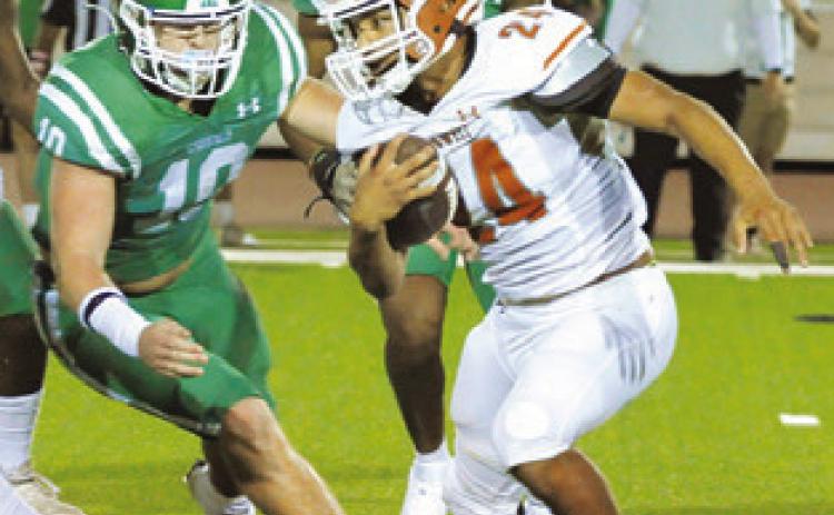 ADIAN TORRES of Caldwell carries the ball against Cuero in the Hornets loss last Friday.